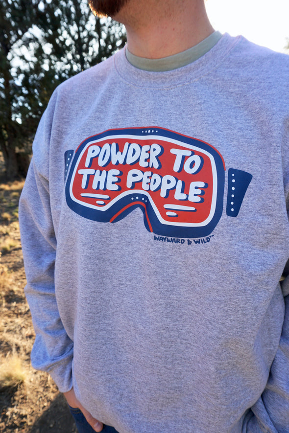Gray sweatshirt with 'Powder to the People' graphic worn by a person outdoors.