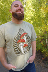 Man wearing a t-shirt with a mushroom design in a forest setting