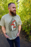 Man wearing a t-shirt with a mushroom design outdoors