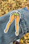 Sticker of legs with 'Private Property' text on a denim jacket against a blurred natural background