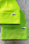 A picture showing the color difference of the neon yellow and neon green beanies