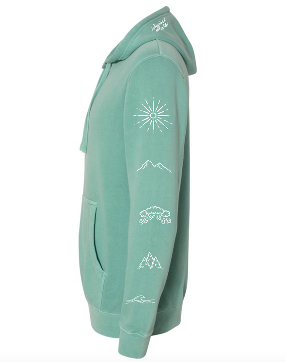 Side view of pigment wash mint green Elements Hoodie with hand drawn symbols on each sleeve representing the elements fire, earth, air and water. Photo also shows the Wayward & Wild script hood print.