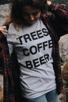 Kolbi lloyd wearing the TREES COFFE BEER T-Shirt with a little pine tree by "BEER" styled with a red flannel